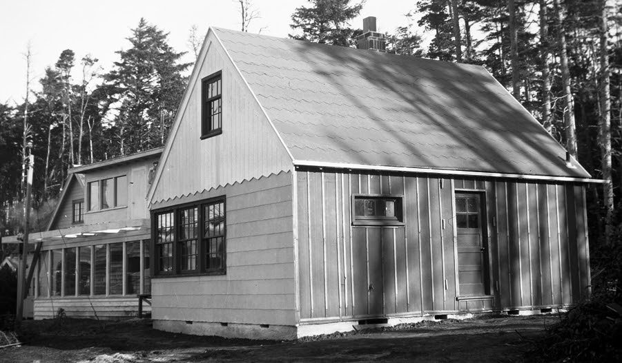 Photo 12: The cabin at the end of the 1947 construction season: The south side is covered with tar paper. If you look carefully, you can see Jewel Lantz standing on the front deck of his home.