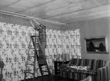 Photos 22 and 23: Dave puts up plastic sheeting, and Janet installs ceiling tiles.