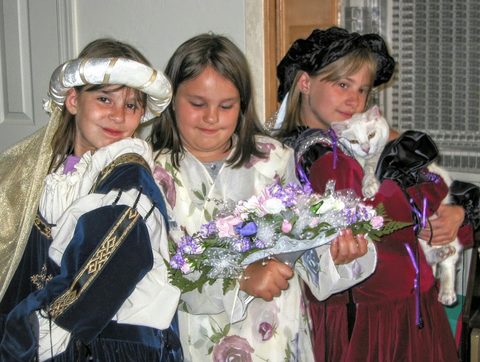Felicia, Stephanie and Kristen show Oliver (the cat) how to play dress-up.