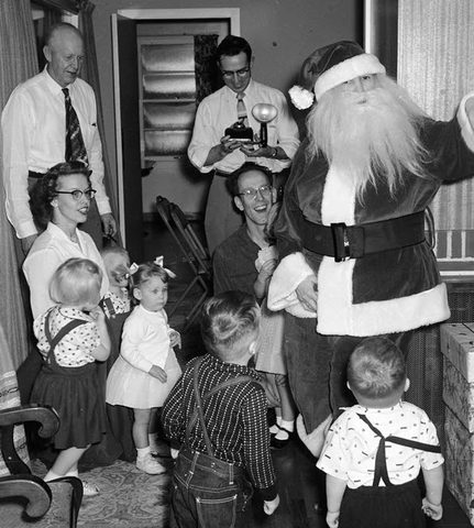 Santa Claus came to visit the kids in Grants Pass. Adults are Austin Brownell, Nancy Lee, Bob Lee, Jack Brownell and Santa. Kids are Kathy, John, Martha, Dave and Bill.