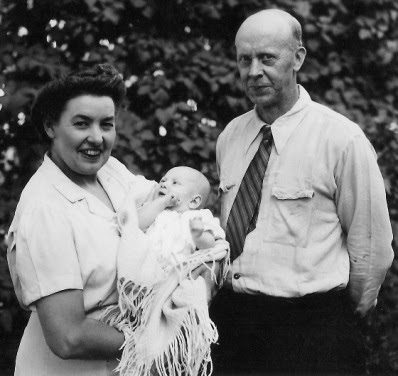 In this picture of my grandparents, Ruth and Austin B. Brownell, they may be dressed in their working clothes. Ruth managed a gift shop which also sold appliances. Austin's rumpled shirt seems to have holes in the sleeve and might be what he wore running an electrical contracting firm. This photo was taken in Grants Pass, Oregon around August, 1945 when I was about 12 weeks old.