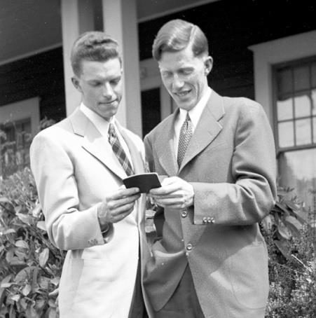 Jim Lantz and Wes Sullivan look at a passport.