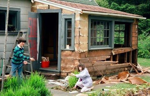 Joel Sullivan and Gail Sullivan help tear down the rotten side porch.