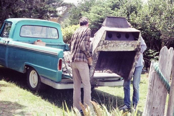 Steve and Dave load the old "Heatalator" into Dave's pickup truck. The Heatalator has rusted out completely, and instead of sending warmed air into the cabin, it sent smoke and soot.