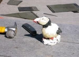 Getting inspiration from our mascot: While not technically a part of the roofing project, we took the time to replace the cabin mascot. Our original puffin was made from plaster and had begun to dissolve in the coastal rain.