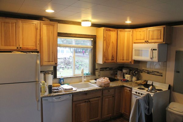 Now: the same wall in 2014, with granite counters, a dishwasher and a microwave over the range.