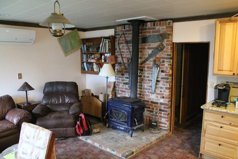 In the upper left corner you can see the inside portion of the heat pump. One of Dave's friends installed a larger wood stove making it possible to burn larger pieces of wood.