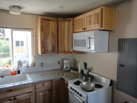 Granite countertops, cabinets, and appliances are all installed.